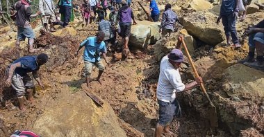 Villagers search through a landslide in Yambali, in the Highlands of Papua New Guinea, May 26, 2024. (AP Photo)