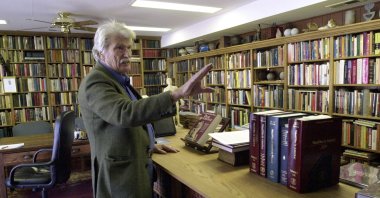 Schuyler Jones talks about the bookcases he built that line his library Wichita, Kansas, U.S., Feb. 6, 2006. (AP Photo)