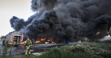 Ukrainian rescuers working at the site of shelling of the hypermarket in Kharkiv, Ukraine, May 25, 2024. (EPA Photo)