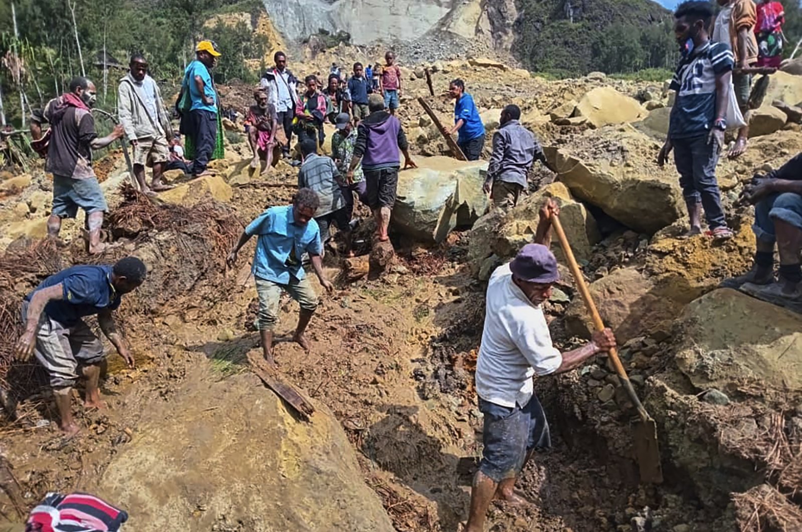 Villagers search through a landslide in Yambali, in the Highlands of Papua New Guinea, May 26, 2024. (AP Photo)