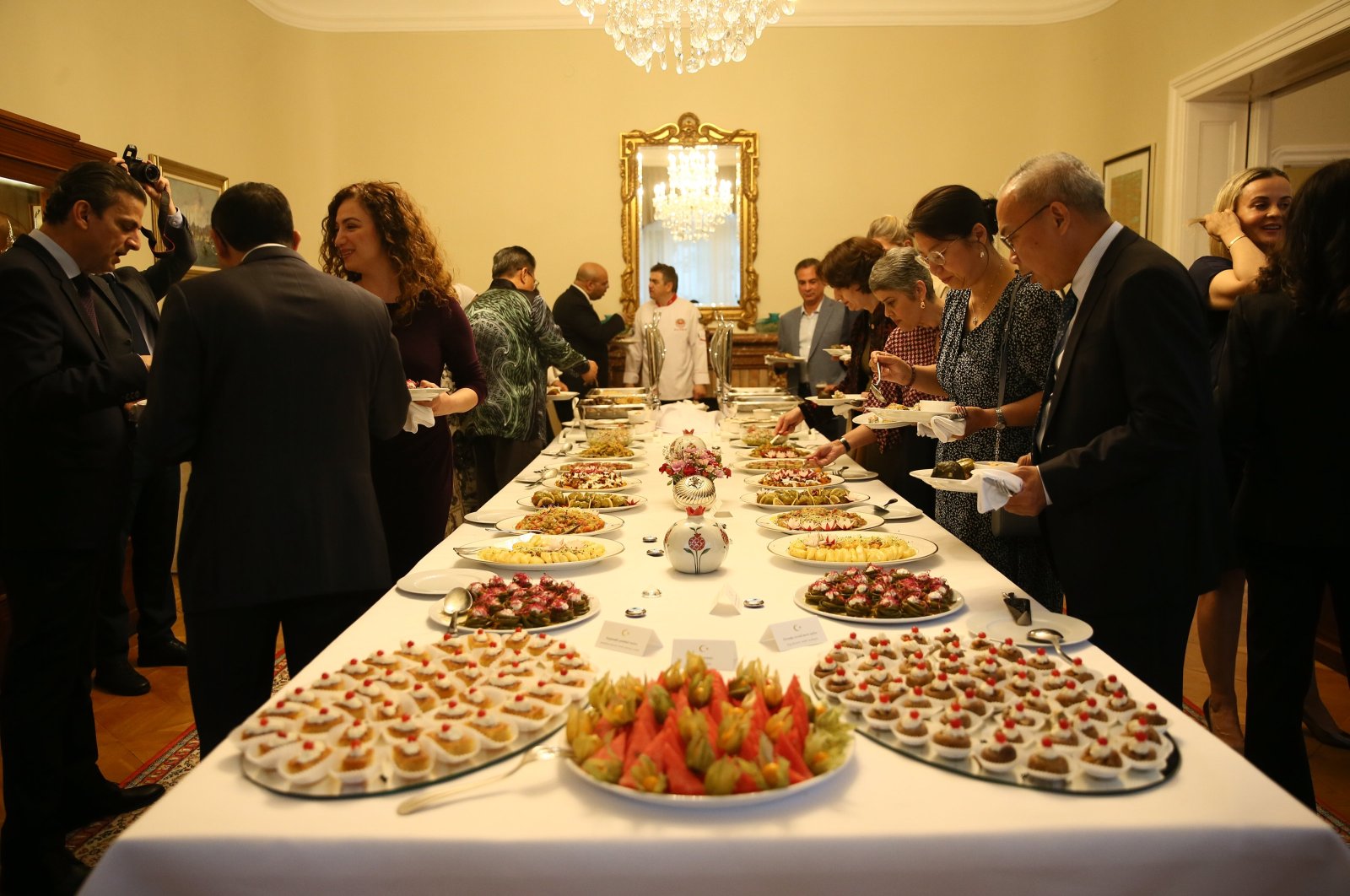 Ambassador Levent Eler (L), Türkiye&#039;s permanent representative to the United Nations office in Vienna, and his wife, Ayten Eler, present tastes from the Aegean region, Vienna, Austria, May 24, 2024. (AA Photo)