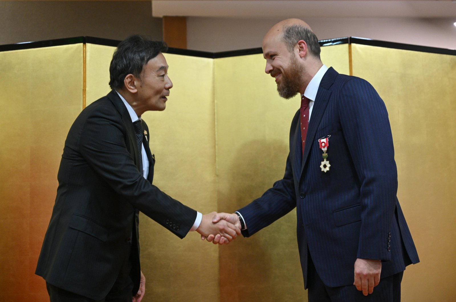 Japanese Ambassador to Ankara Takahiko Katsumata (L) greets Bilal Erdoğan after awarding him the "Order of the Rising Sun, Gold Rays with Rosette," in Ankara, Türkiye, May 25, 2024. (AA Photo)