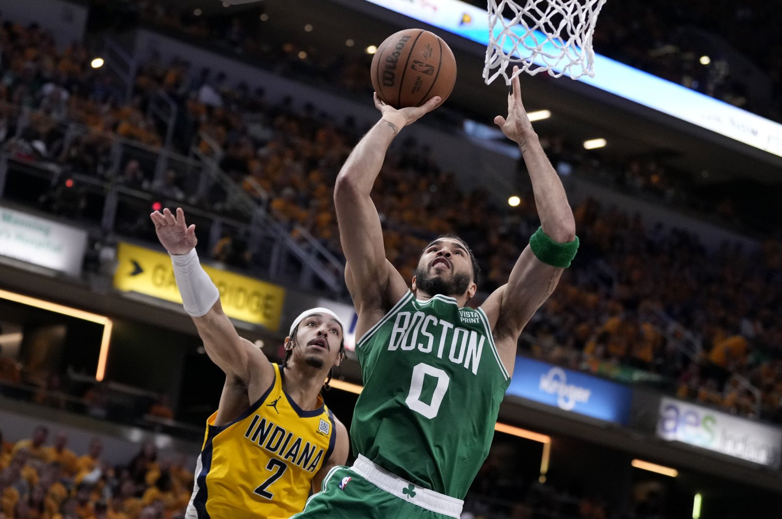 Boston Celtics forward Jayson Tatum (R) drives to the basket past Indiana Pacers guard Andrew Nembhard during an NBA Eastern Conference finals game, Indianapolis, U.S., May 25, 2024. (AP Photo)