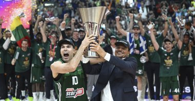 Panathinaikos' captain Kostas Sloukas (L) and coach Ergin Ataman raise the EuroLeague trophy after beating Real Madrid in the final, Berlin, Germany, May 26, 2024. (AA Photo)