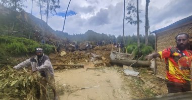 Villagers search through a landslide in Yambali in the Highlands of Papua New Guinea, May 26, 2024. (AP Photo)