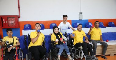 Turkish teacher with cerebral palsy, Yavuz Öndem (3rd R) poses for a photo with his students, Şanlıurfa, Türkiye, May 27, 2024. (AA Photo)