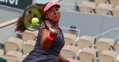 Japan's Naomi Osaka plays a forehand return to Italy's Lucia Bronzetti during their women's singles match on day one of The French Open tennis tournament on Court Philippe-Chatrier at the Roland Garros Complex, Paris, France, May 26, 2024. (AFP Photo)
