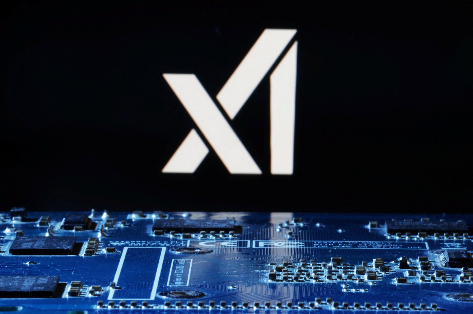 The logo of xAI is seen near the computer motherboard in this illustration taken on Jan. 8, 2024. (Reuters Photo)