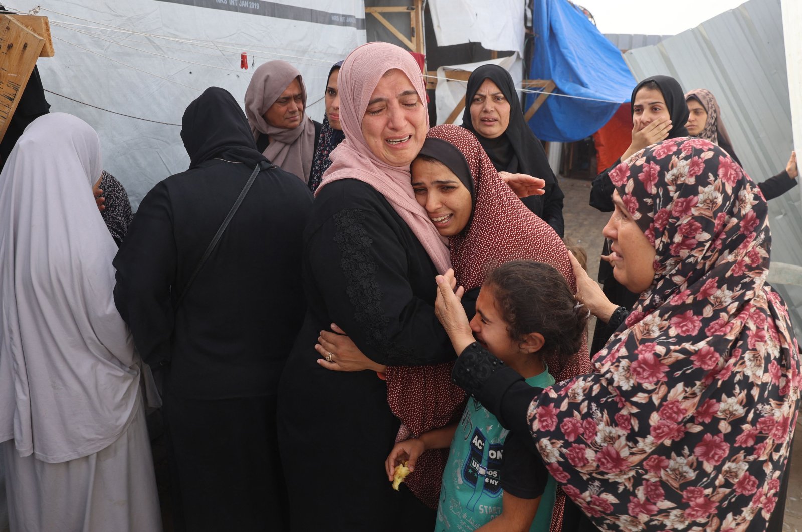Palestinians mourn by the bodies of relatives killed after an Israeli strike on a camp for internally displaced people in Rafah, Palestine, May 27, 2024. (AFP Photo)