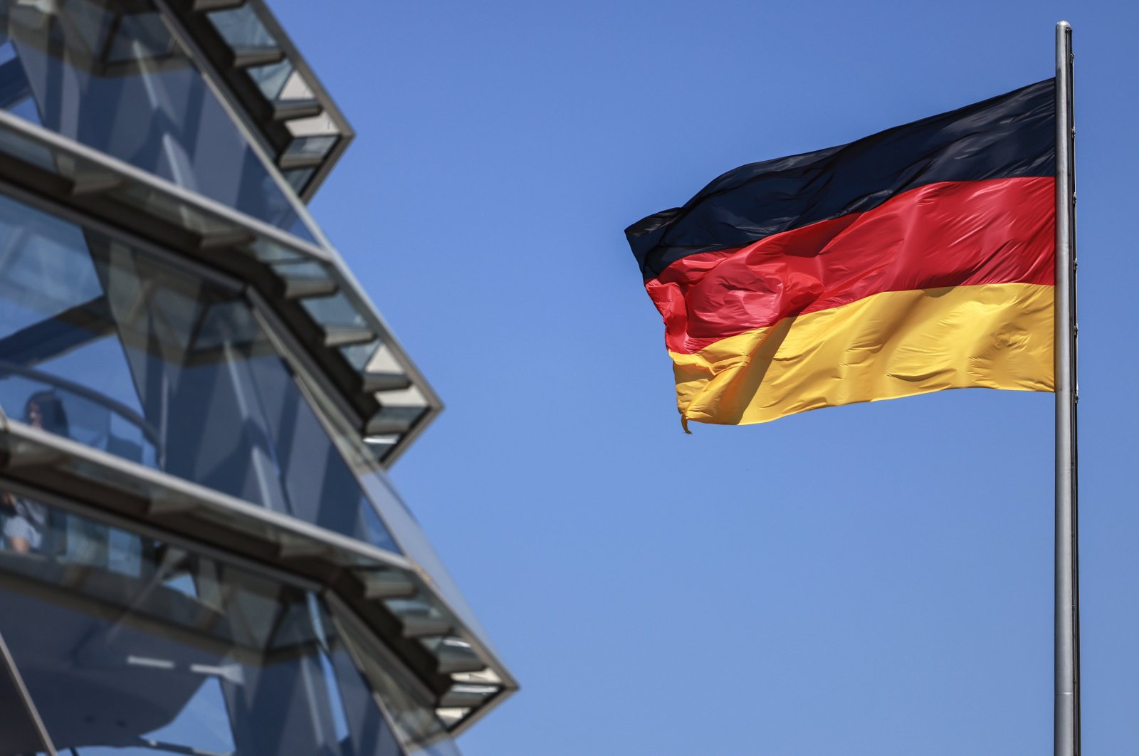 A German flag flutters in the wind on top of the Bundestag, Berlin, Germany, May 15, 2024. (EPA Photo)