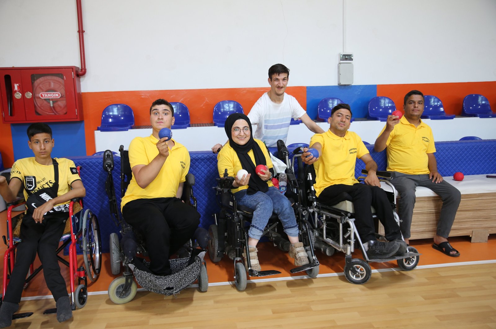 Turkish teacher with cerebral palsy, Yavuz Öndem (3rd R) poses for a photo with his students, Şanlıurfa, Türkiye, May 27, 2024. (AA Photo)