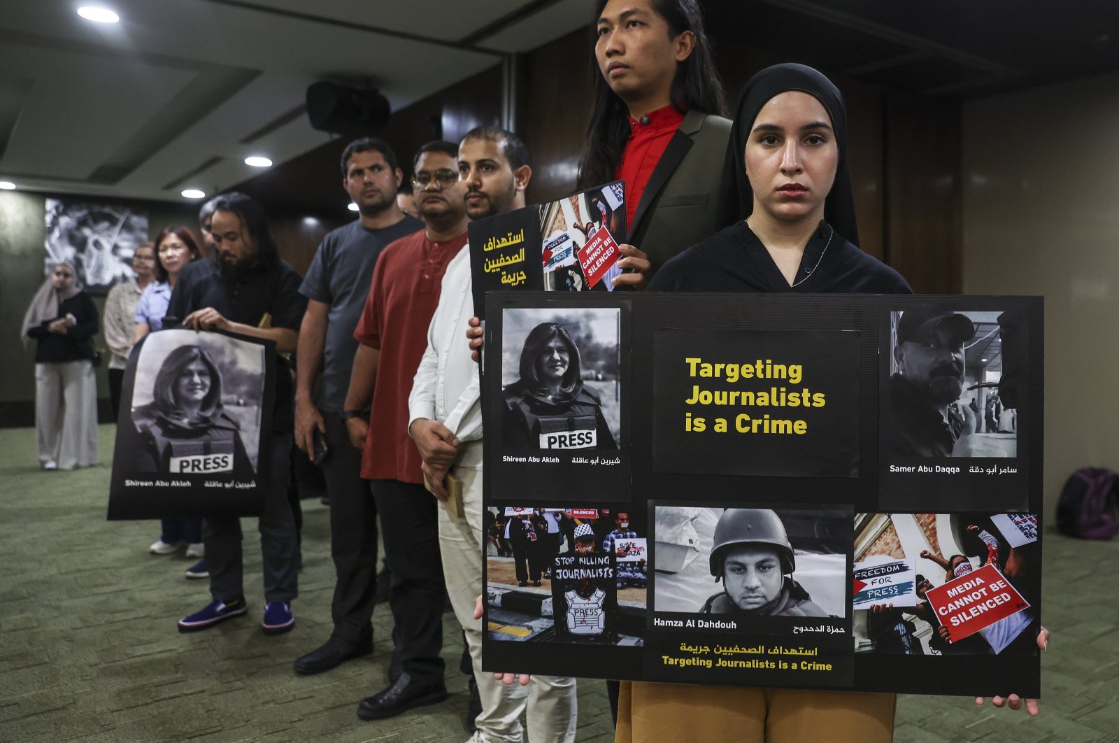 Protesters hold placards reading, "Targeting Journalist is a Crime," in solidarity with Palestinian journalists killed during reporting, in Kuala Lumpur, Malaysia, May 3, 2024. (EPA Photo)