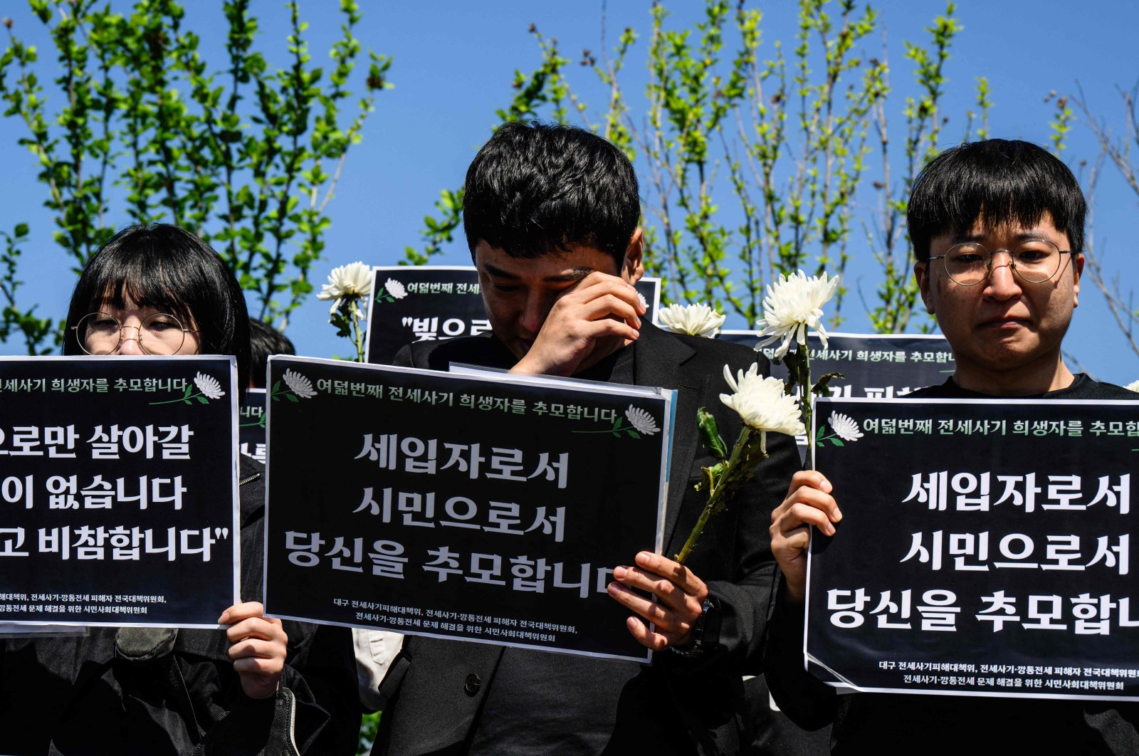 &quot;Jeonse&quot; real estate scam victims react at a rally near the National Assembly, during which signs were held that translate as &quot;I pay tribute to you as a tenant and as a citizen,&quot; in tribute to the latest scam victim who killed themself, in Seoul, South Korea, May 8, 2024. (AFP Photo)