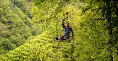Mehmet Şen rides the cable car in the village of Dağınıkksu, in the northeastern province of Rize, Türkiye, May 10, 2024. (AFP Photo)