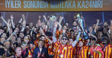 Galatasaray players celebrate with the Süper Lig and Super Cup trophies at RAMS Park, Istanbul, Türkiye, May 27, 2024.  (AA Photo)