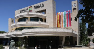A man walks outside the municipality building in the West Bank city of Ramallah, adorned with flags of Spain, Ireland and Norway, West Bank, Palestine, May 24, 2024. (AFP Photo)