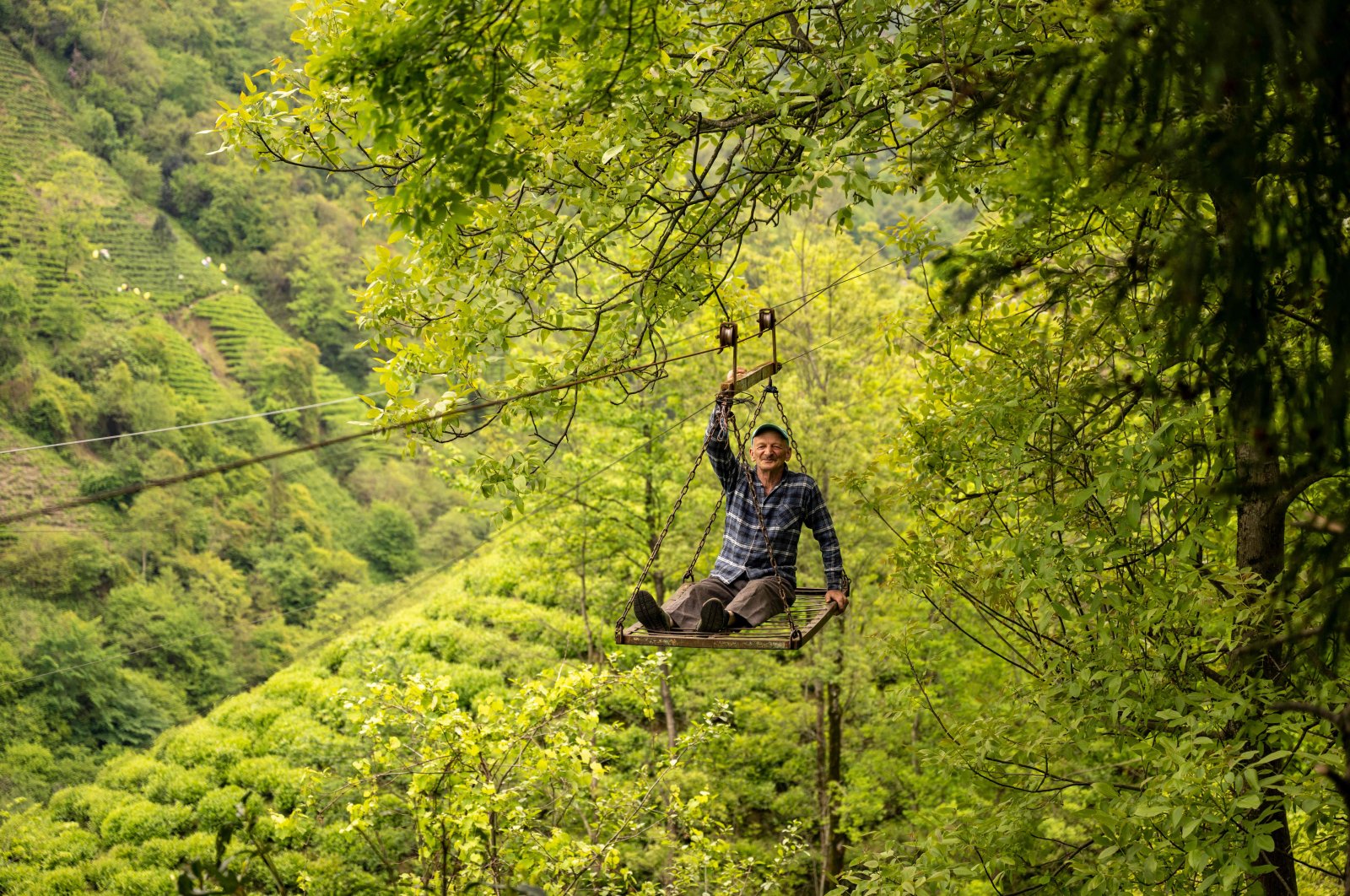 Mehmet Şen rides the cable car in the village of Dağınıkksu, in the northeastern province of Rize, Türkiye, May 10, 2024. (AFP Photo)