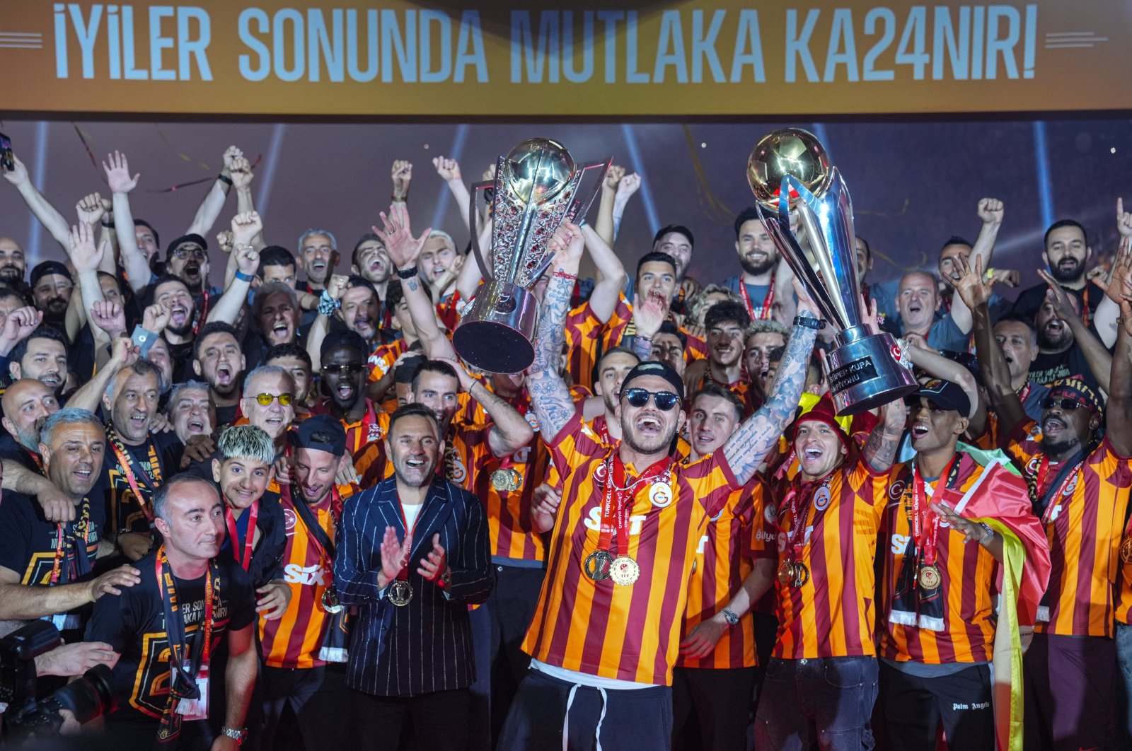 Galatasaray players celebrate with the Süper Lig and Super Cup trophies at RAMS Park, Istanbul, Türkiye, May 27, 2024.  (AA Photo)
