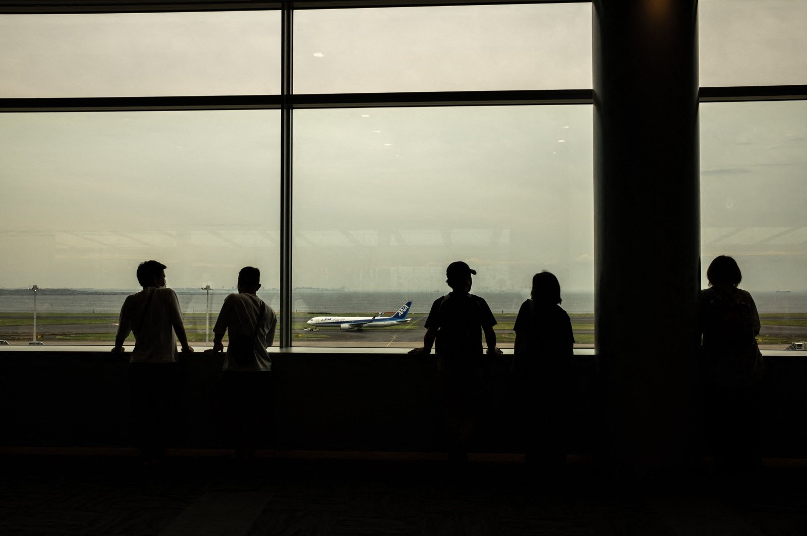 People gather at the observation area of the departures hall at Haneda airport, Tokyo, Japan, April 29, 2024. (AFP Photo)