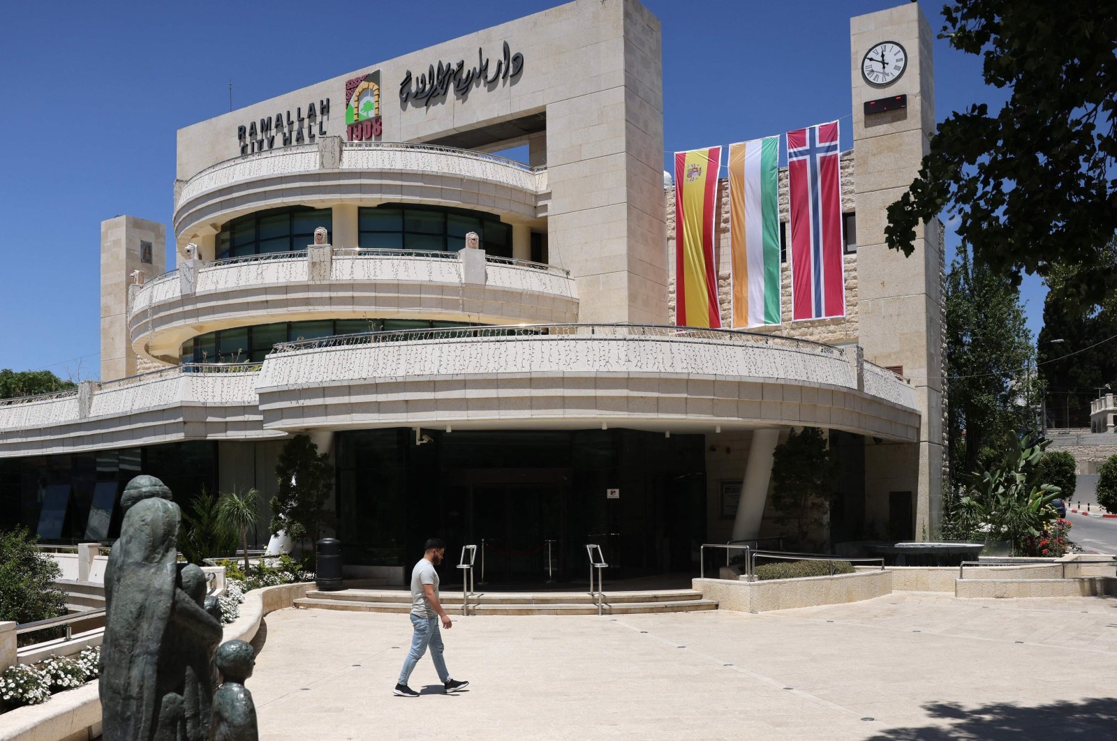 A man walks outside the municipality building in the West Bank city of Ramallah, adorned with flags of Spain, Ireland and Norway, West Bank, Palestine, May 24, 2024. (AFP Photo)