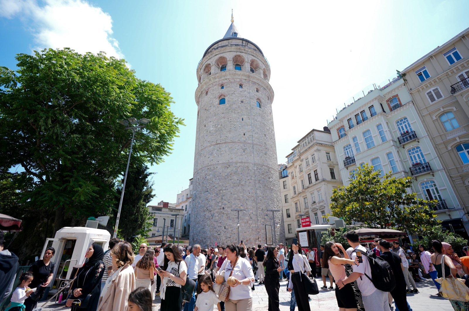 Tourists are photographed near the iconic Galata Tower, reopened after restoration, Istanbul, Türkiye, May 25, 2024. (AA Photo)