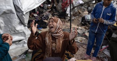 A woman reacts as Palestinians inspect the aftermath of Israel's airstrike on a tent camp in an area previously designated by the Israeli army as safe for displaced Palestinians, Rafah, southern Gaza Strip, Palestine, May 28, 2024. (EPA Photo)