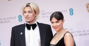 Millie Bobby Brown (L) and Jake Bongiovi pose for photographers upon arrival at the 75th British Academy Film Awards, BAFTA&#039;s, London, U.K., March 13, 2022. (AP Photo)
