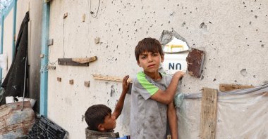 Palestinian boys stand near a damaged structure at the site of an Israeli strike a day earlier on a camp for internally displaced people in Rafah in the southern Gaza Strip, Palestine, May 28, 2024. (AFP Photo)