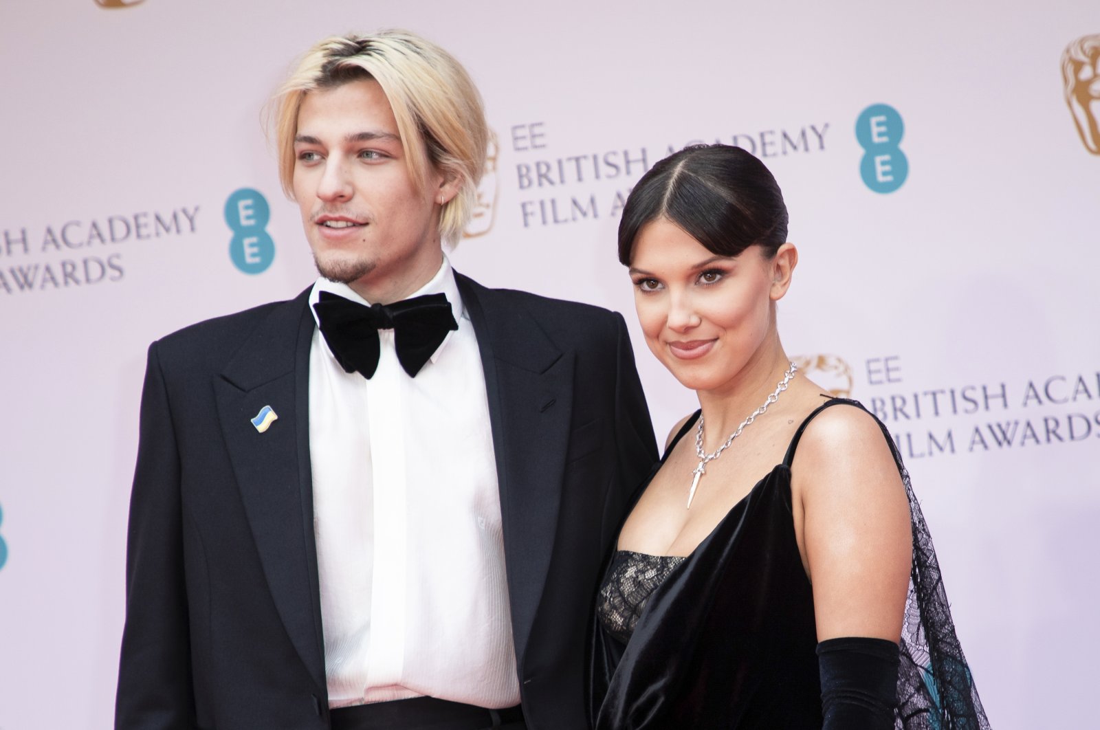 Millie Bobby Brown (L) and Jake Bongiovi pose for photographers upon arrival at the 75th British Academy Film Awards, BAFTA&#039;s, London, U.K., March 13, 2022. (AP Photo)