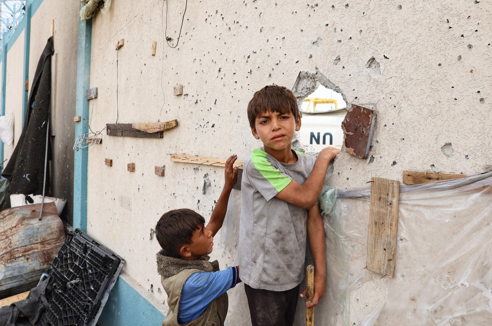 Palestinian boys stand near a damaged structure at the site of an Israeli strike a day earlier on a camp for internally displaced people in Rafah in the southern Gaza Strip, Palestine, May 28, 2024. (AFP Photo)