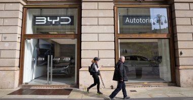 People walk in front of a BYD Auto and Autotorino store, Milan, Italy, March 20, 2024. (Reuters Photo)