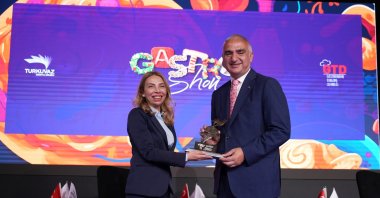 Culture and Tourism Minister Mehmet Nuri Ersoy (R) and Printed Media Advertisement Manager and Executive Board Member of Turkuvaz Media Ceyda Uzman pose during the Gastroshow event, Istanbul, Türkiye, May 30, 2024. (Photo courtesy of Turkuvaz Media)