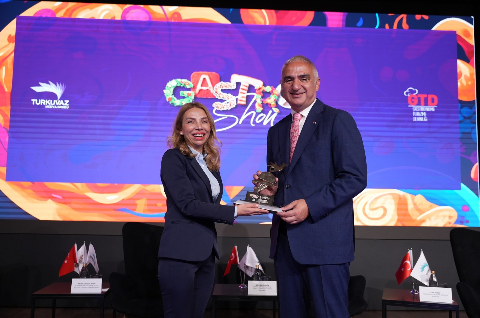 Culture and Tourism Minister Mehmet Nuri Ersoy (R) and Printed Media Advertisement Manager and Executive Board Member of Turkuvaz Media Ceyda Uzman pose during the Gastroshow event, Istanbul, Türkiye, May 30, 2024. (Photo courtesy of Turkuvaz Media)