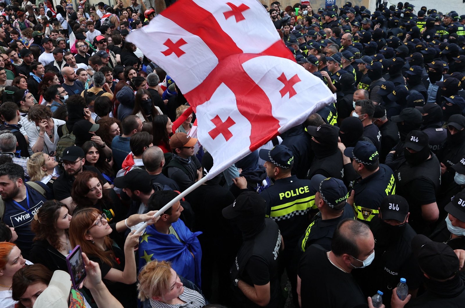 A woman waves a Georgian national flag as she protests the &quot;foreign influence&quot; law outside the parliament building in central Tbilisi, Georgia, May 28, 2024. (AFP Photo)