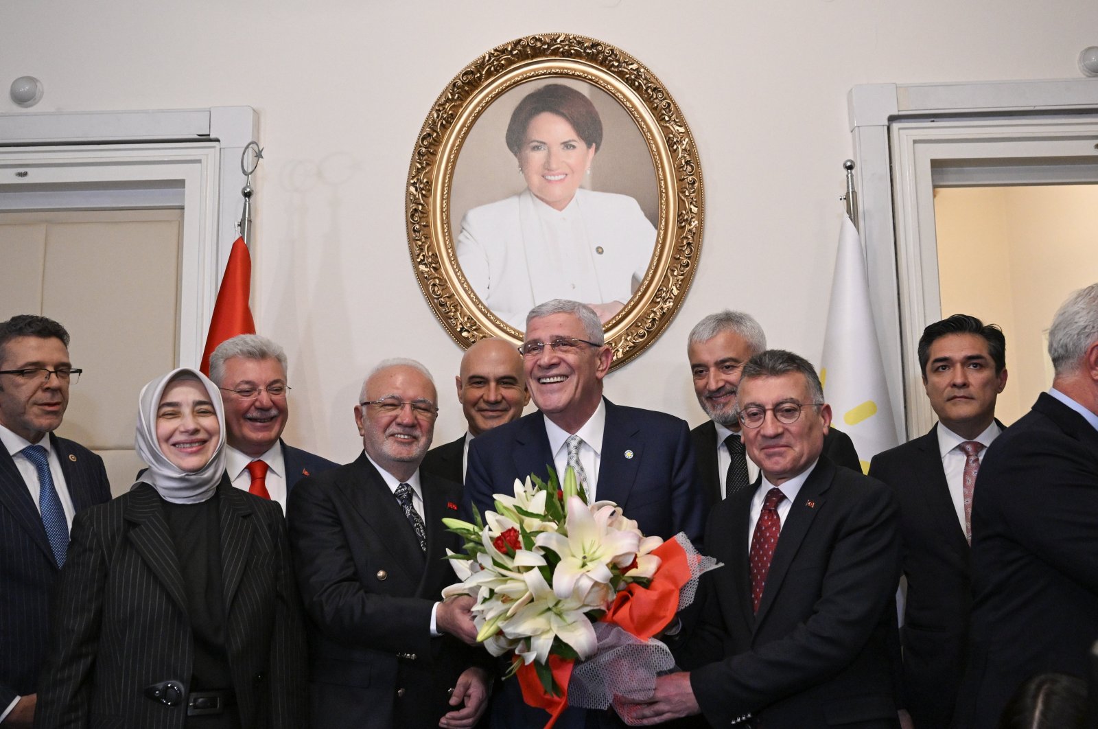 IP leader Müsavat Dervişoğlu (C) poses with AK Party officials in front of a portrait of his predecessor Meral Akşener, at the Turkish Parliament, Ankara, Türkiye, May 30, 2024. (AA Photo)