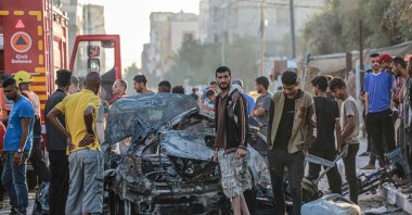 Palestinians check a burnt vehicle following an Israeli strike amid continuing Israeli strikes on Gaza, Gaza Strip, Palestine, May 31, 2024. (AFP Photo)