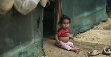 A Syrian child sits outside her family&#039;s tent at a refugee camp outside the village of Miniara, northern Akkar region near the border with Syria, Lebanon, May 20, 2024. (AFP Photo)