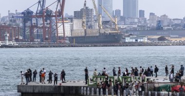 People stand on a pier in the Bosporus before the Haydarpaşa port (back), Istanbul, Türkiye, May 3, 2024. (EPA Photo)