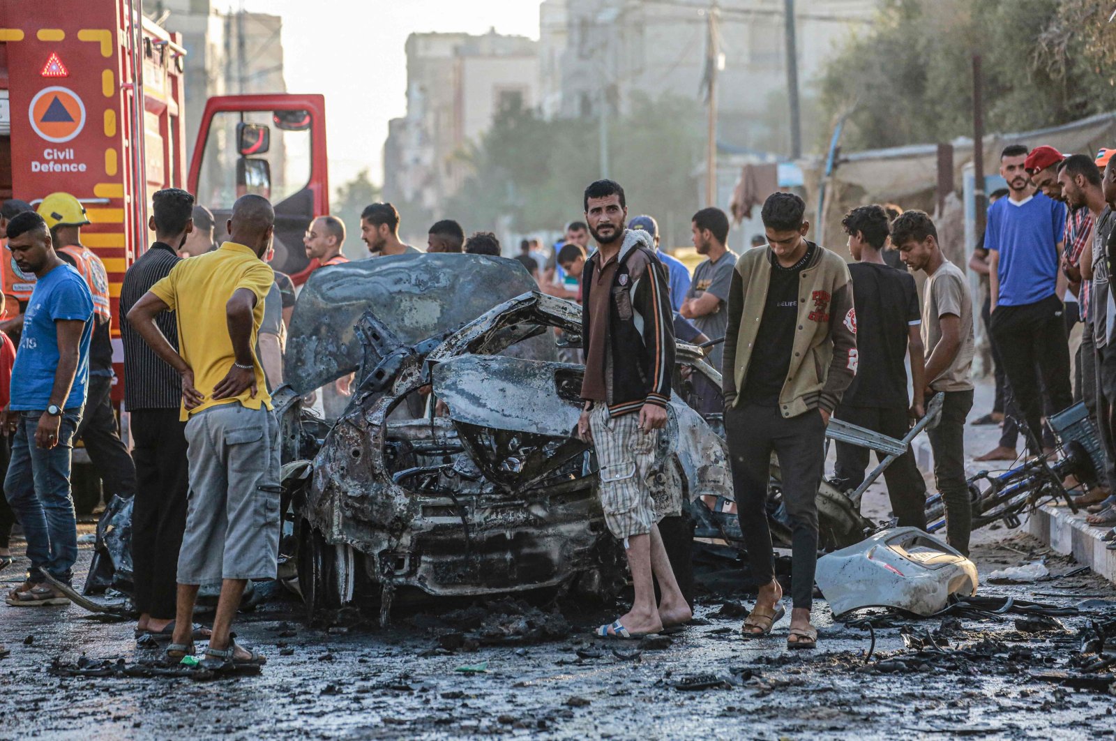 Palestinians check a burnt vehicle following an Israeli strike amid continuing Israeli strikes on Gaza, Gaza Strip, Palestine, May 31, 2024. (AFP Photo)