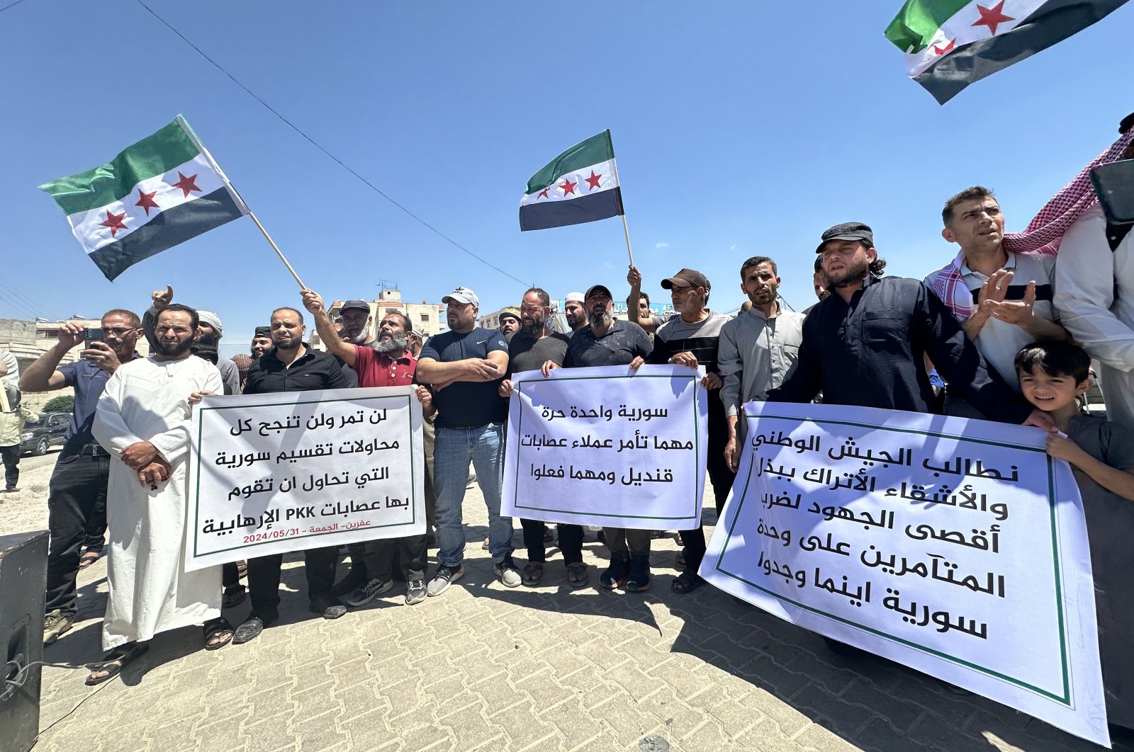 Protesters hold banners condemning PKK/YPG terrorists in northern Syria, May 31, 2024. (AA Photo)