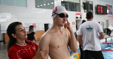 Swimming coach Benan Mandalı (L) trains her autistic son Baha Mandalı, Istanbul, Türkiye, May 29, 2024. (AA Photo)