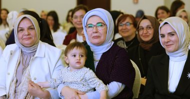 First lady Emine Erdoğan (C) poses with a toddler during a meeting with female members and lawmakers of the ruling Justice and Development Party (AK Party), Ankara, Türkiye, June 2, 2024. (AA Photo)