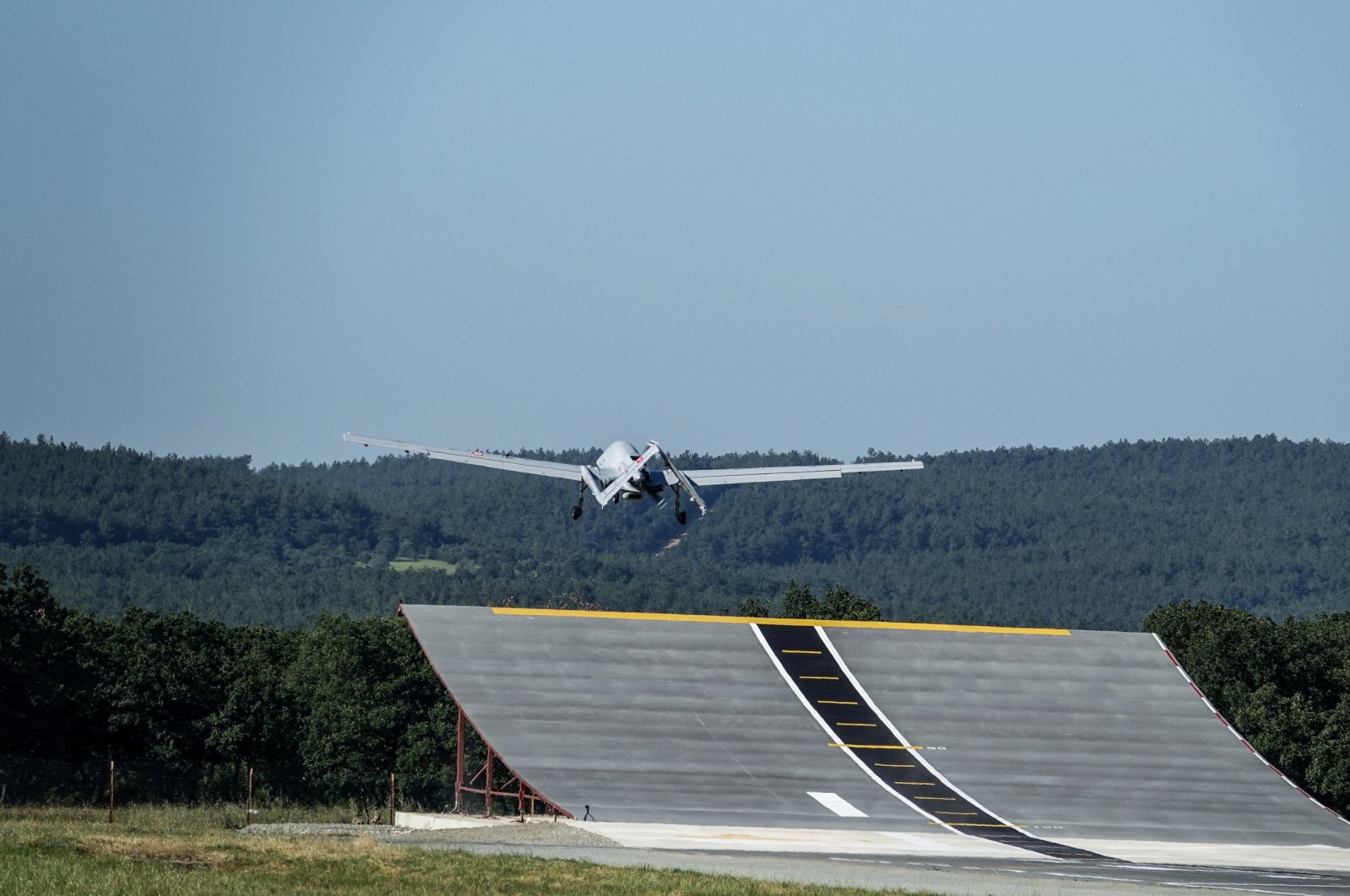 The Bayraktar TB3 combat drone takes off from an upward-curved ramp at Baykar Flight Training and Test Center in Keşan, Edirne, northwestern Türkiye, June 1, 2024. (AA Photo)