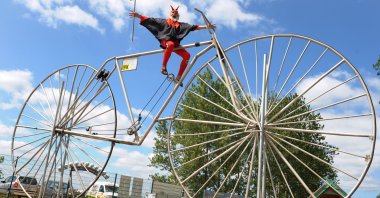 Bicycle designer Dieter (Didi) Senft sits on what its creator claims is the &quot;largest functional bicycle in the world,&quot; Pudagla, Germany, June 1, 2012. (DPA Photo)