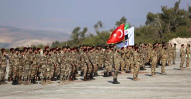 Syrian fighters from the 1st Corps of the Samarkand Brigade take part in a military parade in the opposition-held Afrin, northern Syria, Nov. 23, 2022. (AFP Photo)