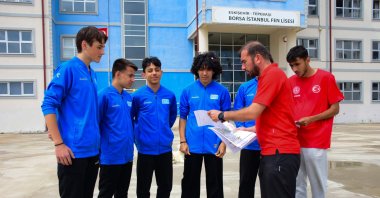 Mehmet Ali Akbaş (2nd R) instructs his students at the Eskişehir Borsa Istanbul Science High School, Eskişehir, Türkiye, May 25, 2024. (AA Photo)