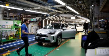Employees work on the Yaris Cross car assembly line at the Toyota Motor Manufacturing France (TMMF) plant in Onnaing near Valenciennes, France, April 4, 2024. (Reuters Photo)