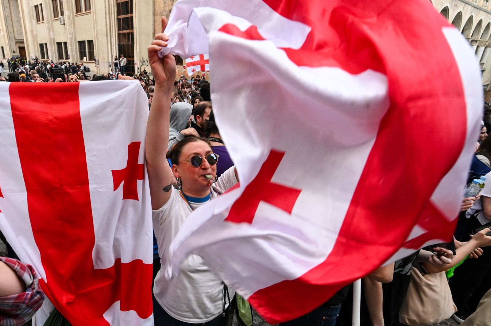 A woman waves a Georgian national flag as she protests the "foreign influence" law outside the parliament building in central Tbilisi, Georgia, May 28, 2024. (AFP Photo)