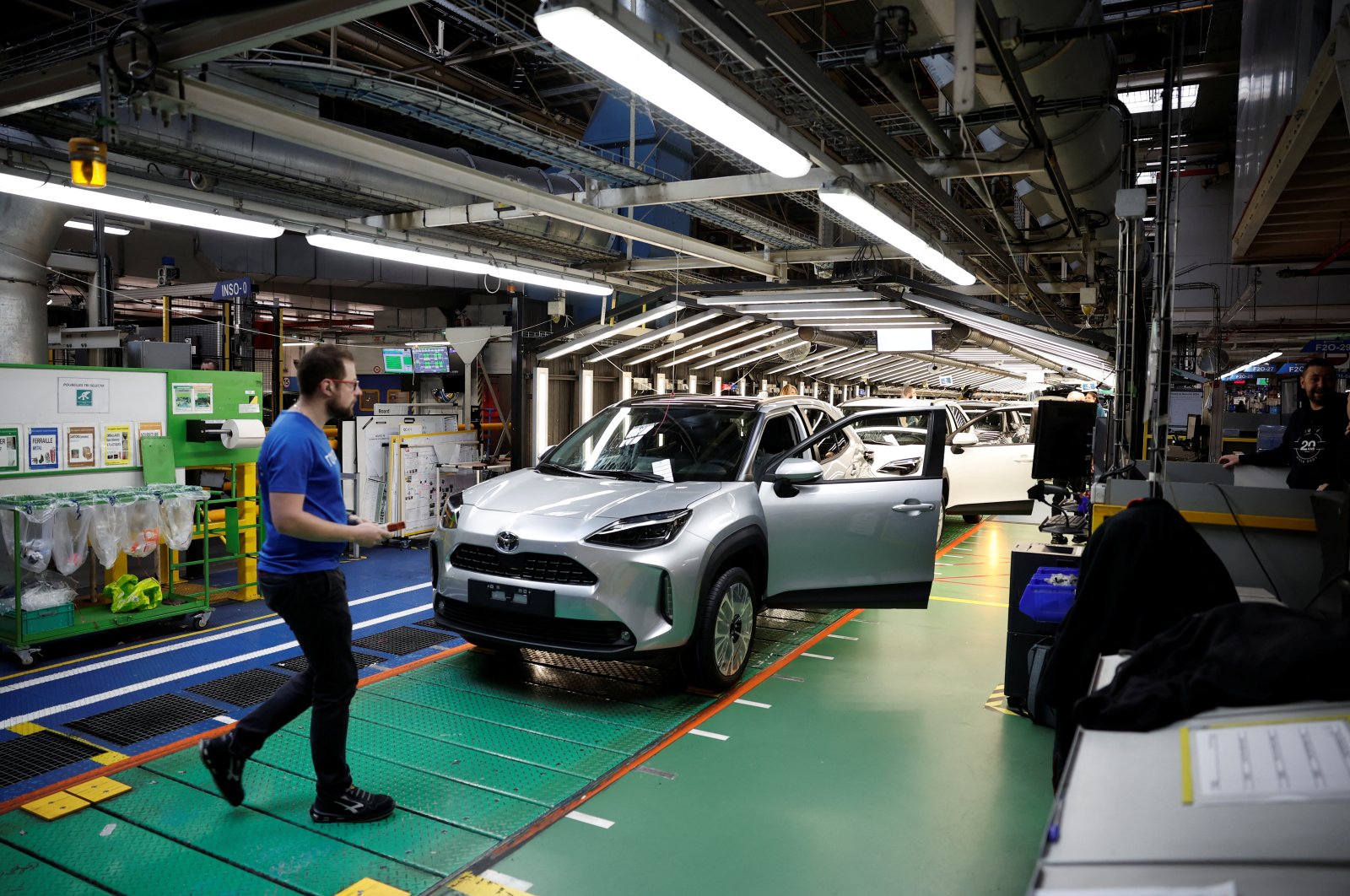 Employees work on the Yaris Cross car assembly line at the Toyota Motor Manufacturing France (TMMF) plant in Onnaing near Valenciennes, France, April 4, 2024. (Reuters Photo)