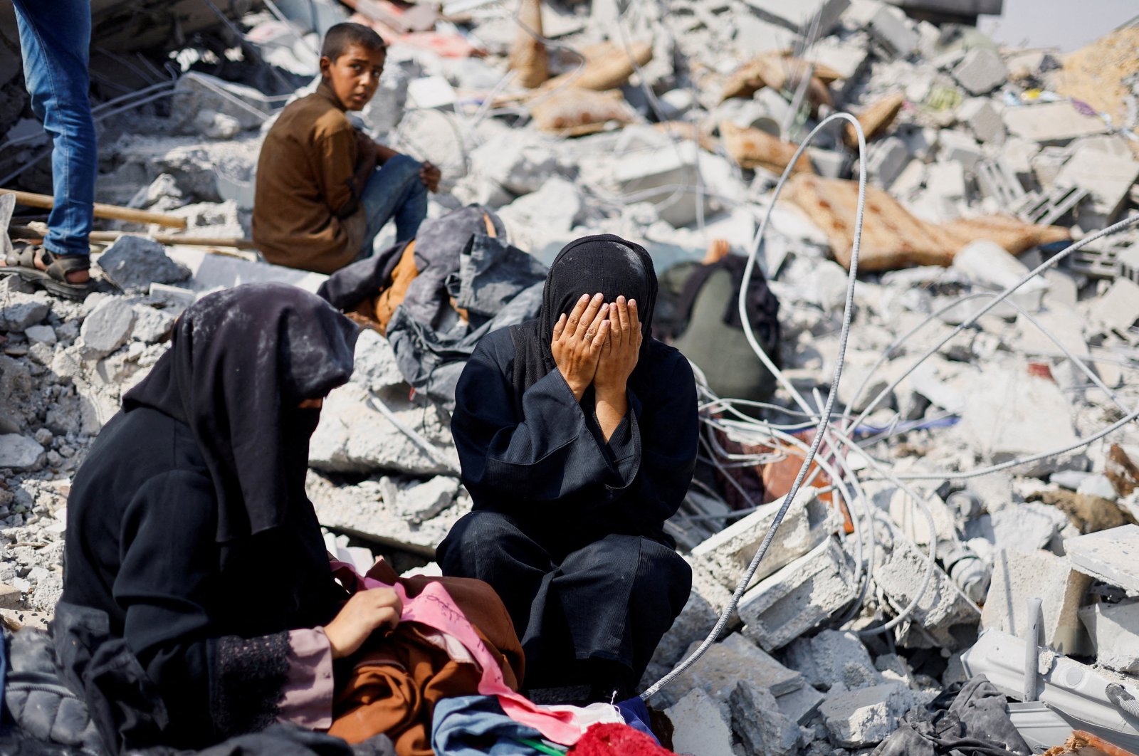 Palestinian sisters Samar and Sahar react as they search for their missing mother Amira al-Breim at the rubble of a house hit in an Israeli strike, in Khan Younis, southern Gaza Strip, Palestine, June 3, 2024. (Reuters Photo)